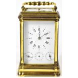 A 20th century French brass carriage clock, the enamelled dial set with Roman and Arabic numerals,