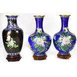 A pair of cloisonné vases of globular form depicting chrysanthemums and butterflies on a blue