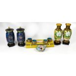 Boxed cloisonné ware comprising a pair of blue ground covered vases with wooden stands,