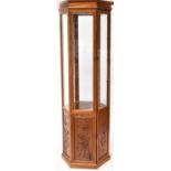 A contemporary Oriental hardwood hexagonal display cabinet, the upper section with bevelled glass,