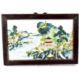 A Chinese Famille Verte panel depicting a temple within a mountainous river landscape, 25 x 41cm,