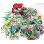 A large quantity of costume jewellery to include various coloured beads, base metal chains, bangles,