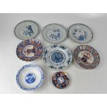 A group of eight Japanese and Chinese plates to include Meiji Period Japanese plates in the Imari