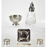 A collection of hallmarked silver items to include two napkin rings, an ashtray, small footed bowl,