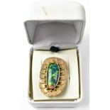 A modern 9ct gold and opal brooch, the elongated oval opal with dominant green,