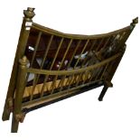 A late 19th/early 20th century brass bedstead with curved top rail,