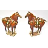 A pair of reproduction Sancai glazed Tang-style horses on square section bases, 69 x 68cm (2).