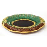 A Victorian c1880 majolica bread platter with oval brown panel to the centre and ochre basket weave