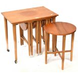 A retro teak nest of three drop-leaf tables contained below a rectangular side table,