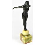 An Art Deco spelter figurine of a slender young woman, 'The Diver', on a later onyx base,