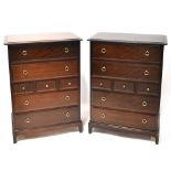 A pair of Stag Minstrel dark stained chestS of drawers, each with four long and three short drawers,