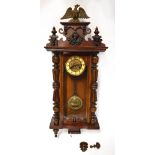 A late 19th century German mahogany cased Vienna-style wall clock, with eagle finial,