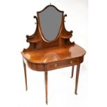 An Edwardian inlaid mahogany dressing table with shield-shaped mirror to the top,