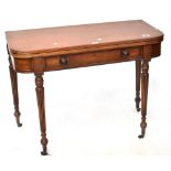 A 19th century style mahogany fold-over tea table with single frieze drawer on reeded tapering legs