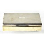 An Elizabeth II hallmarked silver cigarette box with wooden lining, Harman Brothers,