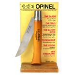 OPINEL; a large counter top advertising display lock knife mounted on pine base,