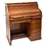 An early 20th century walnut roll top desk with fitted interior,