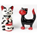 Two Lorna Bailey cats, one a seated black and white cat playing the bongo drums,