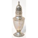 An Edwardian hallmarked silver sugar caster of octagonal baluster form, with pierced dome lid,