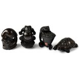 Four Japanese carved wooden netsuke comprising a tortoise, a frog wearing a loin cloth,