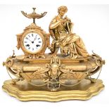 A late 19th century Neo-Classical design gilt metal figural mantel clock with Classical lady sat on