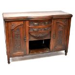 An Edwardian mahogany serpentine front sideboard with two central drawers,