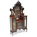 A Victorian mahogany mirror back display cabinet, shaped mirror above heavily carved canopy,