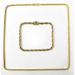 A 9ct gold thin rope twist necklace, length 40cm and a 9ct gold double chain link bracelet,