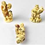 Three Japanese netsuke comprising a fisherman holding up a fish,