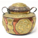 A 20th century Middle Eastern copper and brass lidded storage vessel,