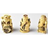 Three Japanese netsuke in the form of wise men, one holding a staff,