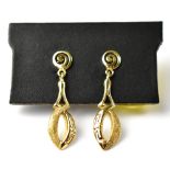 A pair of modern 14ct gold drop earrings, the lower hoop with a Greek Key and rough texture design,