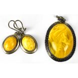 A hallmarked silver pendant set with oval honey amber and a pair of similar drop earrings (2).