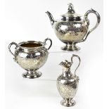 A Victorian hallmarked silver three piece tea service comprising teapot with centurion helmet