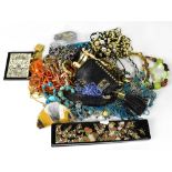 A large quantity of costume jewellery to include coloured beads, necklaces, bangles, bracelets,