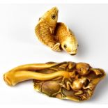 A Japanese netsuke in the form of two frogs sitting on a lily pad and a pair of carp intertwined,