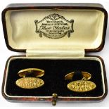 A pair of gentlemen's hallmarked 9ct gold oval cufflinks, one with engine turned floral pattern,