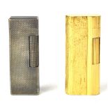 DUNHILL; a gold-plated bark effect lighter and a further white base metal example (2).