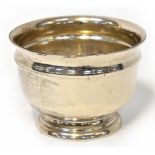 A George VI hallmarked silver bowl of squat circular form, raised on a stepped foot, Edward Viner,