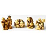 Four Japanese carved netsuke comprising a seated figure holding a mask,