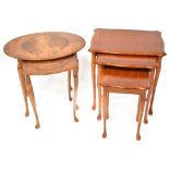 A nest of three line inlaid cross banded yew wood occasional tables with shaped tops and raised on