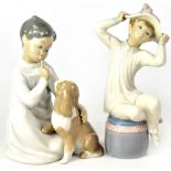 A Lladró figure of a boy in nightshirt with a spaniel on his knee, no.