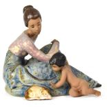 A Lladró matt glazed figure of a mother seated with her toddler at her feet reaching for a cat, no.