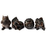 Four Japanese carved wooden netsuke comprising an owl, a horse lying down,