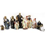 A group of ten 20th century ceramic figures to include a Japanese wood cutter standing on a rocky