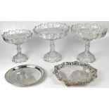 Three Edwardian cut glass table centres each with detachable circular footed base,