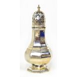 A George V hallmarked footed silver sugar caster of octagonal baluster form with pierced cover,