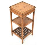 A reproduction Oriental hardwood square section jardinière stand with central shelf and lower