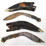 Two identical large kukri knives, with ornate inset wire metal horn handles, with lion mask pommels,