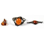 A silver bangle set with oval cabochon amber in Art Nouveau style mount,